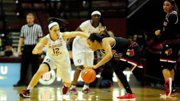 TALLAHASSEE, FL - JANUARY 12: Asia Durr (25) guard Louisville Cardinals stumbles with the basketball against Brittany Brown (12) guard Florida State University (FSU) Seminoles in an Atlantic Coast Conference (ACC) match-up on Thursday, January 12, 2017, at Donald L. Tucker Civic Center in Tallahassee, Florida. FSU wins 65-72. (Photo by David Allio/Icon Sportswire via Getty Images)