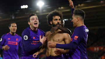 SOUTHAMPTON, ENGLAND - APRIL 05: Mohamed Salah of Liverpool celebrates with team mates Roberto Firmino of Liverpool and Andy Robertson of Liverpool after scoring their team's second goal during the Premier League match between Southampton FC and Liverpool FC at St Mary's Stadium on April 05, 2019 in Southampton, United Kingdom. (Photo by Mike Hewitt/Getty Images)