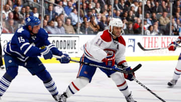 TORONTO - OCTOBER 7: Tomas Kaberle #15 of the Toronto Maple Leafs chops Scott Gomez #11 of the Montreal Canadiens during a regular season NHL game against the Toronto Maple Leafs at the Air Canada Centre October 7, 2010 in Toronto, Ontario, Canada. (Photo by Abelimages/Getty Images)