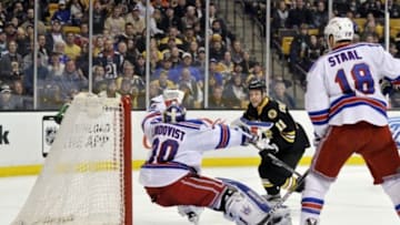 Mar 28, 2015; Boston, MA, USA; New York Rangers goalie Henrik Lundqvist (30) makes a glove save in front of Boston Bruins center Gregory Campbell (11) and defenseman Marc Staal (18)during the xx period at TD Banknorth Garden. Mandatory Credit: Bob DeChiara-USA TODAY Sports