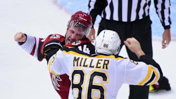 Oct 17, 2015; Glendale, AZ, USA; Arizona Coyotes center Joe Vitale (14) and Boston Bruins defenseman Kevan Miller (86) fight during the second period at Gila River Arena. Mandatory Credit: Matt Kartozian-USA TODAY Sports