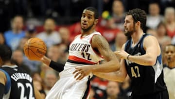 April 1, 2012; Portland, OR, USA; Portland Trail Blazers power forward LaMarcus Aldridge (12) battles for position with Minnesota Timberwolves power forward Kevin Love (42) during the fourth quarter of the game at the Rose Garden. The Blazers won the game 119-106. Mandatory Credit: Steve Dykes-USA TODAY Sports