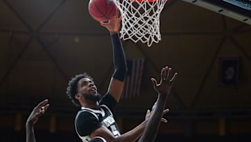 Feb 26, 2022; Laramie, Wyoming, USA; Nevada Wolf Pack forward Warren Washington (5) shoots against Wyoming Cowboys forward Graham Ike (33) during the first half at Arena-Auditorium. Mandatory Credit: Troy Babbitt-USA TODAY Sports
