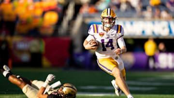 Auburn footballJan 2, 2023; Orlando, FL, USA; LSU Tigers quarterback Walker Howard (14) rushes with the ball during the second half against the Purdue Boilermakers at Camping World Stadium. Mandatory Credit: Matt Pendleton-USA TODAY Sports