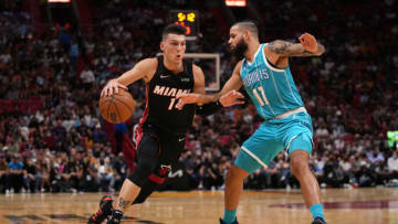 Miami Heat guard Tyler Herro (14) drives the ball around Charlotte Hornets forward Cody Martin( Jasen Vinlove-USA TODAY Sports)