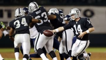 Aug 28, 2014; Oakland, CA, USA; Oakland Raiders quarterback Matt McGloin (14) hands off to Oakland Raiders running back George Atkinson (34) during the third quarter in a game against the Seattle Seahawks at O.co Coliseum. Mandatory Credit: Bob Stanton-USA TODAY Sports