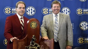 Dec 4, 2015; Atlanta, GA, USA; Alabama Crimson Tide head coach Nick Saban and Florida Gators head coach Jim McElwain pose with the SEC trophy between the SEC coaches press conference at the Georgia Dome. Mandatory Credit: John David Mercer-USA TODAY Sports