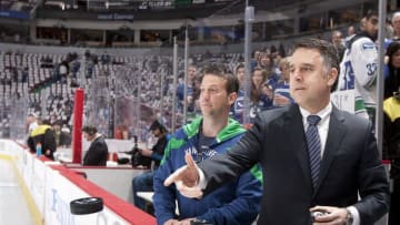 VANCOUVER, CANADA - APRIL 11: Assistant general manager Laurence Gilman of the Vancouver Canucks tosses pucks onto the ice for the pre-game warmup before the start of Game One of the Western Conference Quarterfinals between the Los Angeles Kings and the Canucks during the 2012 NHL Stanley Cup Finals at Rogers Arena on April 11, 2012 in Vancouver, British Columbia, Canada. (Photo by Jeff Vinnick/NHLI via Getty Images)