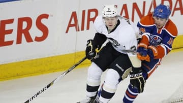 Jan 10, 2014; Edmonton, Alberta, CAN; Edmonton Oilers forward Jordan Eberle (14) chases Pittsburgh Penguins defenseman Olli Maata (3) around the Pittsburgh net during the first period at Rexall Place. Mandatory Credit: Perry Nelson-USA TODAY Sports