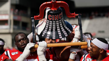 Members of the Cincinnati Bearcats celebrate with The Victory Bell after defeating the Miami Redhawks. USA Today.