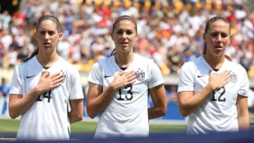 Aug 16, 2015; Pittsburgh, PA, USA; United States midfielder Morgan Brian (14) and forward Alex Morgan (13) and midfielder Lauren Holiday (12) stand for the playing of the national anthem before playing Costa Rica at Heinz Field. The United States won 8-0. Mandatory Credit: Charles LeClaire-USA TODAY Sports