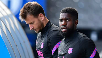 Barcelona defender Samuel Umtiti (R) and goalkeeper Neto arrive for a training session. (Photo by PAU BARRENA/AFP via Getty Images)