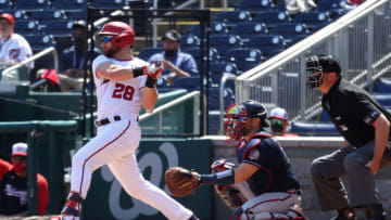 Apr 7, 2021; Washington, District of Columbia, USA; Washington Nationals catcher Jonathan Lucroy (28) hits a single against the Atlanta Braves in the first inning at Nationals Park. Mandatory Credit: Geoff Burke-USA TODAY Sports