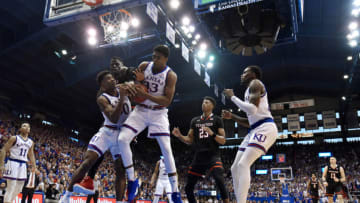 LAWRENCE, KANSAS - FEBRUARY 02: Ochai Agbaji #30 and David McCormack #33 of the Kansas Jayhawks battle for a rebound against Norense Odiase #32 of the Texas Tech Red Raiders in the second half at Allen Fieldhouse on February 02, 2019 in Lawrence, Kansas. (Photo by Ed Zurga/Getty Images)