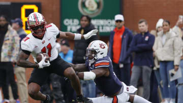 Auburn footballNov 19, 2022; Auburn, Alabama, USA; Auburn Tigers linebacker Owen Pappoe (0) dives to tackle Western Kentucky Hilltoppers wide receiver Malachi Corley (11) during the first quarter at Jordan-Hare Stadium. Mandatory Credit: John Reed-USA TODAY Sports