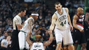 Mar 2, 2016; Boston, MA, USA; Boston Celtics guard Isaiah Thomas (4) and center Tyler Zeller (44) help up guard Marcus Smart (36) during the first half against the Portland Trail Blazers at TD Garden. Mandatory Credit: Bob DeChiara-USA TODAY Sports