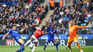 LEICESTER, ENGLAND - APRIL 28: Eddie Nketiah of Arsenal is foiled by Harry Maguire and Kasper Schmeichel of Leicester City during the Premier League match between Leicester City and Arsenal FC at The King Power Stadium on April 28, 2019 in Leicester, United Kingdom. (Photo by Julian Finney/Getty Images)