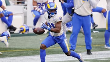 SEATTLE, WASHINGTON - JANUARY 09: Defensive back Darious Williams #31 of the Los Angeles Rams rushes for a touchdown after an interception during the second quarter of the NFC Wild Card Playoff game against the Seattle Seahawks at Lumen Field on January 09, 2021 in Seattle, Washington. (Photo by Steph Chambers/Getty Images)