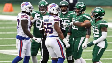 Jerry Hughes #55 of the Buffalo Bills and Greg Van Roten #62 of the New York Jets. (Photo by Elsa/Getty Images)