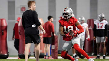 Mar 9, 2023; Columbus, Ohio, USA; Ohio State Buckeyes wide receiver Marvin Harrison Jr. (18) returns a punt during spring football practice at the Woody Hayes Athletic Center. Mandatory Credit: Adam Cairns-The Columbus DispatchFootball Buckeyes Spring Football