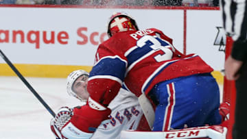 MONTREAL, QC - MAY 17: Chris Kreider #20 of the New York Rangers slides into Carey Price #31 of the Montreal Canadiens during the second period in Game One of the Eastern Conference Final during the 2014 Stanley Cup Playoffs at the Bell Centre on May 17, 2014 in Montreal, Canada. The Rangers defeated the Canadiens 7-2. (Photo by Bruce Bennett/Getty Images)