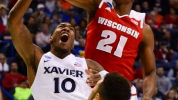 Mar 20, 2016; St. Louis, MO, USA; Wisconsin Badgers forward Khalil Iverson (21) knocks down a shot by Xavier Musketeers guard Remy Abell (10) during the first half of the second round in the 2016 NCAA Tournament at Scottrade Center. Mandatory Credit: Jeff Curry-USA TODAY Sports