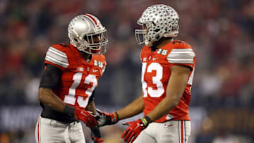 Jan 12, 2015; Arlington, TX, USA; Ohio State Buckeyes cornerback Eli Apple (13) and Ohio State Buckeyes linebacker Darron Lee (43) celebrate during the first quarter against the Oregon Ducks in the 2015 CFP National Championship Game at AT&T Stadium. Mandatory Credit: Tim Heitman-USA TODAY Sports