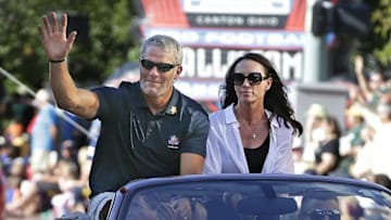 Aug 6, 2016; Canton, OH, USA; Hall of Fame inductee Brett Favre and his wife Deanna Favre wave to the crowd along the parade route during the Canton Repository Grand Parade as part of the NFL Pro Football Hall of Fame Enshrinement Festival. Mandatory Credit: Rick Wood/Milwaukee Journal Sentinel via USA TODAY Network