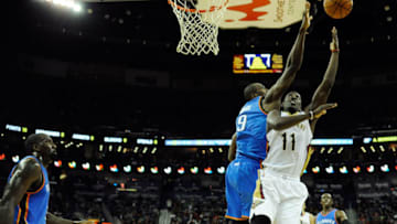 Jrue Holiday #11 of the New Orleans Pelicans is defended by Serge Ibaka #9 (Photo by Stacy Revere/Getty Images)