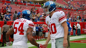 Nov 8, 2015; Tampa, FL, USA; New York Giants quarterback Eli Manning (10) high fives linebacker Jonathan Casillas (54) prior to the game against the Tampa Bay Buccaneers at Raymond James Stadium. Mandatory Credit: Kim Klement-USA TODAY Sports