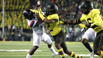 EUGENE, OREGON - NOVEMBER 16: Jaxen Turner #21 of the Arizona Wildcats is tackled by Mykael Wright #2 of the Oregon Ducks in the second quarter during their game at Autzen Stadium on November 16, 2019 in Eugene, Oregon. (Photo by Abbie Parr/Getty Images)