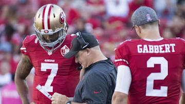 October 23, 2016; Santa Clara, CA, USA; San Francisco 49ers head coach Chip Kelly (center) talks to quarterback Colin Kaepernick (7) and quarterback Blaine Gabbert (2) during the fourth quarter against the Tampa Bay Buccaneers at Levi