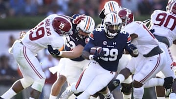 Nov 28, 2015; Auburn, AL, USA; Auburn Tigers running back Jovon Robinson (29) carries the ball past Alabama Crimson Tide linebacker Reggie Ragland (19) and Reuben Foster (10) at Jordan Hare Stadium. Mandatory Credit: RVR Photos-USA TODAY Sports