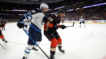 ANAHEIM, CALIFORNIA - OCTOBER 13: Josh Morrissey #44 of the Winnipeg Jets and Benoit-Olivier Groulx #50 of the Anaheim Ducks in the second period at Honda Center on October 13, 2021 in Anaheim, California. (Photo by Ronald Martinez/Getty Images)