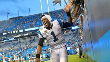 Cam Newton and the Panthers beat Dallas in Week 1. In Week 2, he represented Auburn at a press conference. (Photo by Grant Halverson/Getty Images)