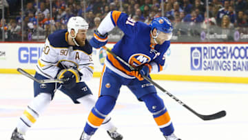 NEW YORK, NY - DECEMBER 27: John Tavares #91 of the New York Islanders drives to the net amid back pressure from Ryan O'Reilly #90 of the Buffalo Sabres during the second period at Barclays Center on December 27, 2017 in New York City. (Photo by Mike Stobe/NHLI via Getty Images)