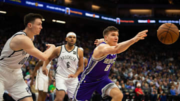 The Sacramento Kings' Bogdan Bogdanovic (8) and the Brooklyn Nets' Rodions Kurucs (00) chase a loose ball at Golden 1 Center in Sacramento, Calif., on Tuesday, March 19, 2019. The Nets won, 123-121. (Paul Kitagaki Jr./Sacramento Bee/TNS via Getty Images)