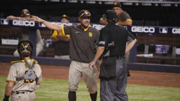 MIAMI, FLORIDA - JULY 24: Skip Schumaker #56 of the San Diego Padres argues with umpire Doug Eddings #88 and gets ejected in the eighth inning against the Miami Marlins at loanDepot park on July 24, 2021 in Miami, Florida. (Photo by Mark Brown/Getty Images)