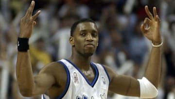 ORLANDO, FL - APRIL 27: Orlando Magic's Tracy McGrady display threes on each hand after shooting a three pointer to the score at 92 points to send the game into overtime during the game against Charlotte Hornets at the first round of Eastern Conference playoffs at the TD Waterhouse Centre in Orlando, FL, 27 April 2002. The Magic lost 100 to 110 as the Hornets pulled ahead and won game three. (Photo credit should read CALVIN KNIGHT/AFP/Getty Images)