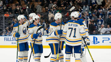 Mar 2, 2022; Toronto, Ontario, CAN; Buffalo Sabres goaltender Craig Anderson (41) celebrates the win with left wing Victor Olofsson (71) and left wing Jeff Skinner (53) against the Toronto Maple Leafs at Scotiabank Arena. Mandatory Credit: Nick Turchiaro-USA TODAY Sports