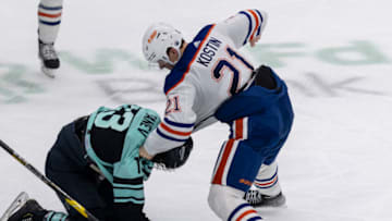 Dec 30, 2022; Seattle, Washington, USA; Edmonton Oilers forward Klim Kostin (21) punches Seattle Kraken forward Brandon Tanev (13) during the third period at Climate Pledge Arena. Mandatory Credit: Stephen Brashear-USA TODAY Sports