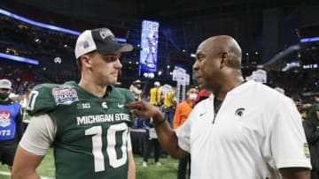 Dec 30, 2021; Atlanta, GA, USA; Michigan State Spartans quarterback Payton Thorne (10) and head coach Mel Tucker talk after a victory against the Pittsburgh Panthers in the 2021 Peach Bowl at Mercedes-Benz Stadium. Mandatory Credit: Brett Davis-USA TODAY Sports