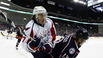 Jan 19, 2016; Columbus, OH, USA; Washington Capitals right wing T.J. Oshie (77) tries to free the puck from Columbus Blue Jackets right wing Cam Atkinson (13) during the first period at Nationwide Arena. Mandatory Credit: Russell LaBounty-USA TODAY Sports