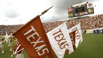 AUSTIN, TX - AUGUST 31: "Texas" flags are brought on to the field during an intermission in the game between the University of Texas at Austin Longhorns and the University of New Mexico Aggies at Texas Memorial Stadium on August 31, 2003 in Austin, Texas. Texas defeated New Mexico 66-7. (Photo by Stephen Dunn/Getty Images)