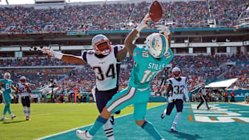 Jan 3, 2016; Miami Gardens, FL, USA; Miami Dolphins wide receiver Kenny Stills (10) is unable to make a catch in the end zone as New England Patriots cornerback Leonard Johnson (34) defends the play during the first half at Sun Life Stadium. Mandatory Credit: Steve Mitchell-USA TODAY Sports