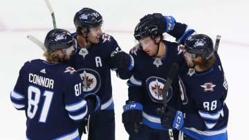 EDMONTON, ALBERTA - JULY 29: Tucker Poolman #3 of the Winnipeg Jets celebrates with teammates after scoring a goal during the first period against the Vancouver Canucks in an exhibition game prior to the 2020 NHL Stanley Cup Playoffs at Rogers Place on July 29, 2020 in Edmonton, Alberta. (Photo by Jeff Vinnick/Getty Images)