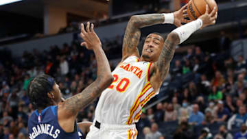 Dec 6, 2021; Minneapolis, Minnesota, USA; Atlanta Hawks forward John Collins (20) grabs the ball away from Minnesota Timberwolves forward Jaden McDaniels (3) in the first quarter at Target Center. Mandatory Credit: Bruce Kluckhohn-USA TODAY Sports
