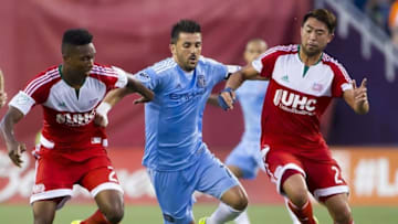 Jul 18, 2015; Foxborough, MA, USA; New York City FC forward David Villa (7) tries to break between New England Revolution defender London Woodberry (28) and New England Revolution forward Lee Nguyen (24) during the first half at Gillette Stadium. Mandatory Credit: Winslow Townson-USA TODAY Sports