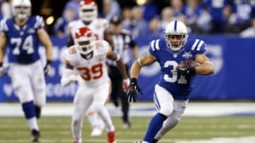Jan 4, 2014; Indianapolis, IN, USA; Indianapolis Colts running back Donald Brown (31) breaks a run into the open field as he runs past Kansas City Chiefs safety Husain Abdullah (39) during the 2013 AFC wild card playoff football game at Lucas Oil Stadium. Indianapolis defeats Kansas City 45-44. Mandatory Credit: Brian Spurlock-USA TODAY Sports