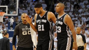 May 31, 2014; Oklahoma City, OK, USA; San Antonio Spurs forward Tim Duncan (21) , guard Patty Mills (left) and forward Boris Diaw (33) celebrate during the second half against the Oklahoma City Thunder in game six of the Western Conference Finals of the 2014 NBA Playoffs at Chesapeake Energy Arena. Mandatory Credit: Mark D. Smith-USA TODAY Sports